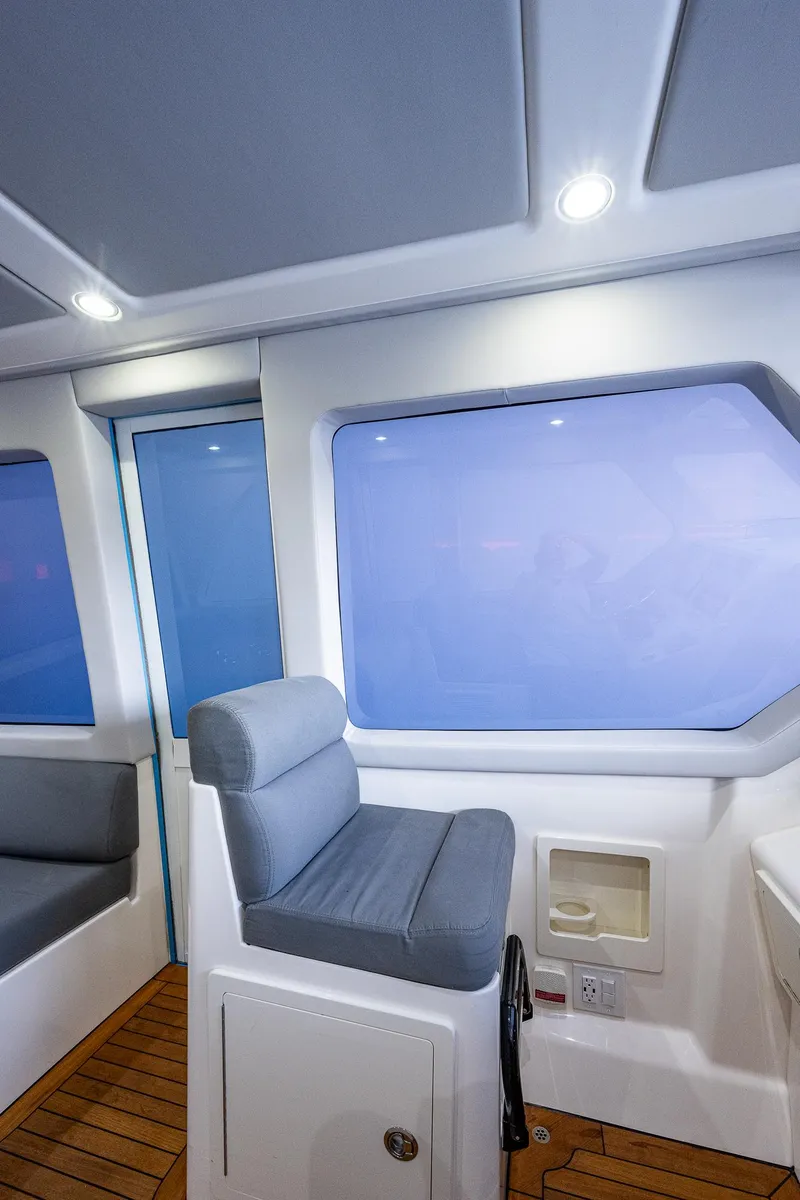 Slide: The Image of Interior of 2021 Gulf Crosser 52 yacht with seating and large windows. - 6