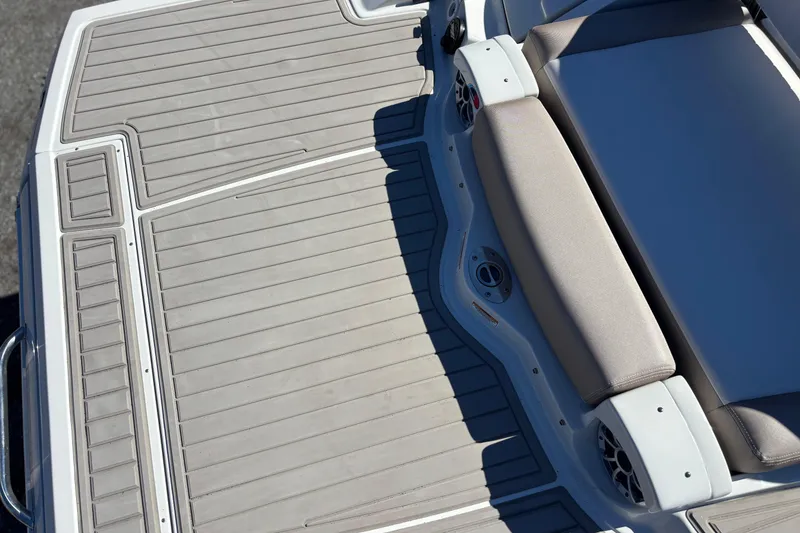 Slide: The Image of 2026 Crownline 278 SS boat deck with cushioned seating and speakers. - 16
