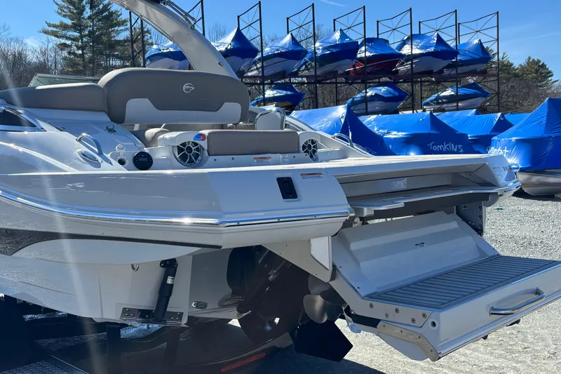 Slide: The Image of 2026 Crownline 278 SS boat with extended swim platform, docked outdoors. - 18