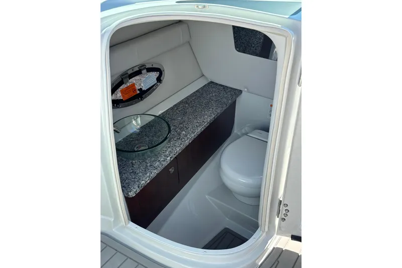 Slide: The Image of 2026 Crownline 278 SS boat interior bathroom with granite countertop and modern fixtures. - 21