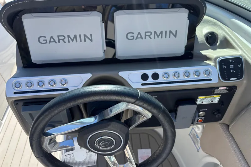 Slide: The Image of 2026 Crownline 278 SS dashboard with Garmin navigation displays and steering wheel. - 5