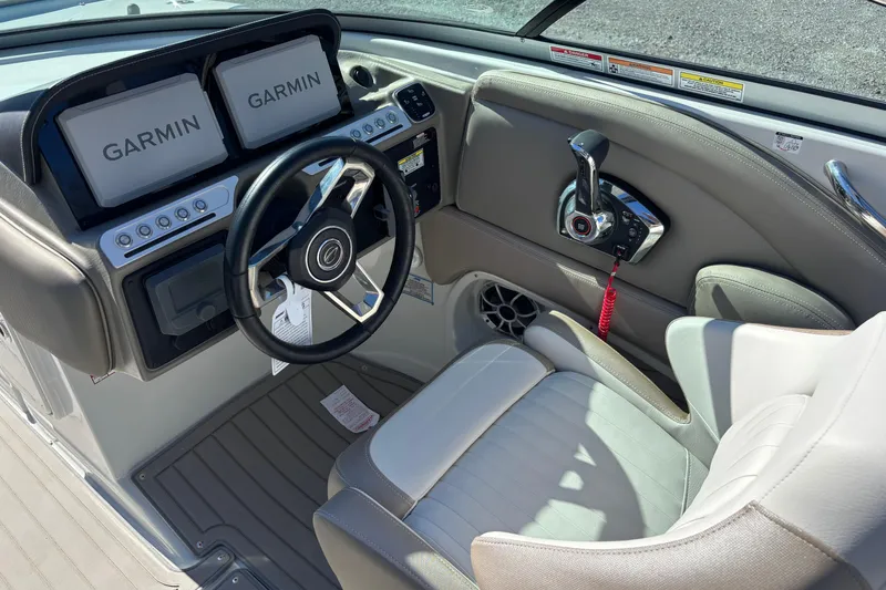 Slide: The Image of 2026 Crownline 278 SS boat cockpit with Garmin displays and modern steering wheel. - 8