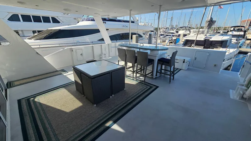 Slide: The Image of Spacious deck of 2009 Custom Flybridge Motoryacht with seating and marina view. - 46