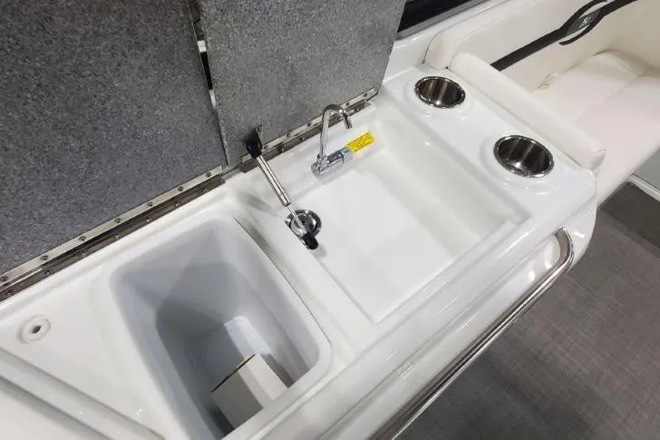 Slide: The Image of 2008 Formula 310 Bowrider boat interior with sink and cup holders. - 14