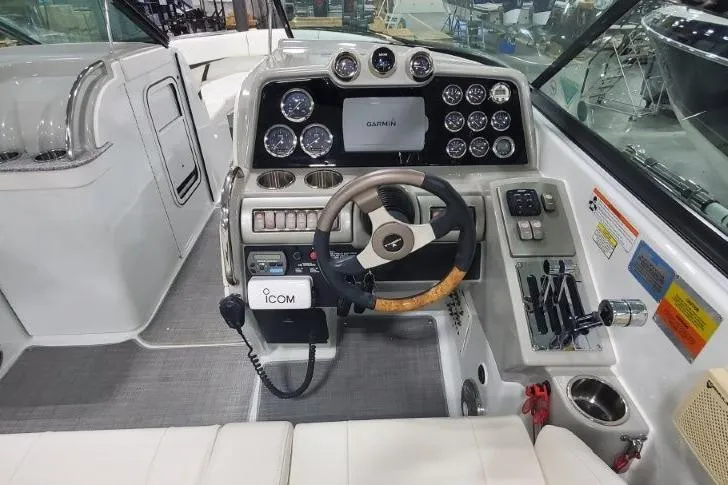 Slide: The Image of 2008 Formula 310 Bowrider dashboard with steering wheel, gauges, and navigation equipment. - 17