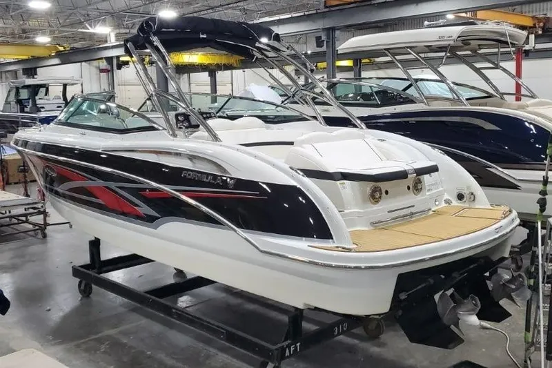 Slide: The Image of 2008 Formula 310 Bowrider boat in showroom, featuring sleek design and modern amenities. - 2