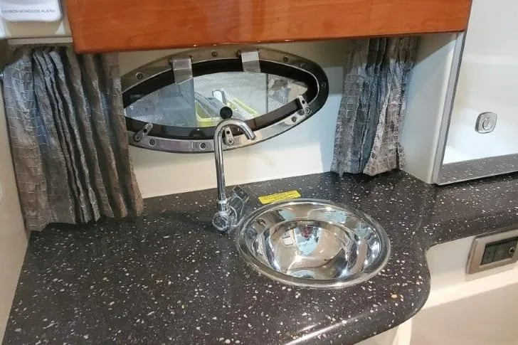 Slide: The Image of 2008 Formula 310 Bowrider interior with sink, countertop, and oval window. - 27