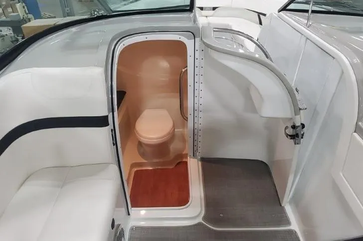 Slide: The Image of 2008 Formula 310 Bowrider boat interior with compact bathroom and seating area. - 28