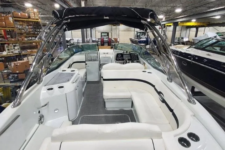 Slide: The Image of 2008 Formula 310 Bowrider interior with white seating and sleek design in a showroom. - 29