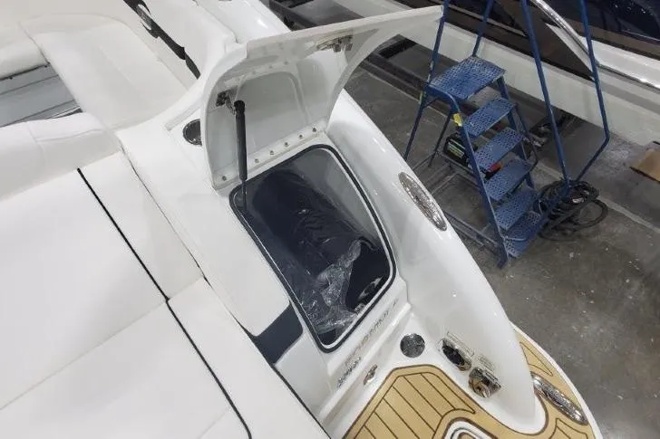 Slide: The Image of 2008 Formula 310 Bowrider boat interior with open storage compartment and teak flooring. - 31