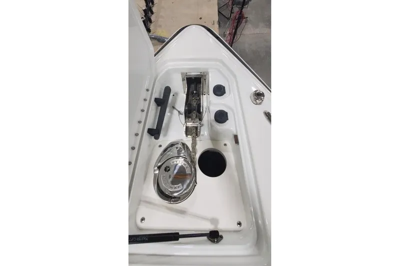 Slide: The Image of 2008 Formula 310 Bowrider anchor compartment with winch and storage features. - 4