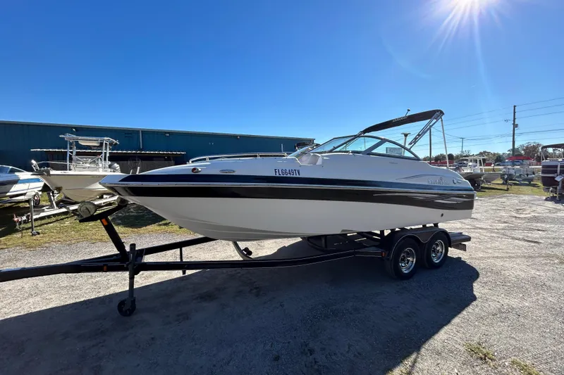 Slide: The Image of 2008 NauticStar 232DC Sport Deck boat on trailer under clear blue sky. - 14
