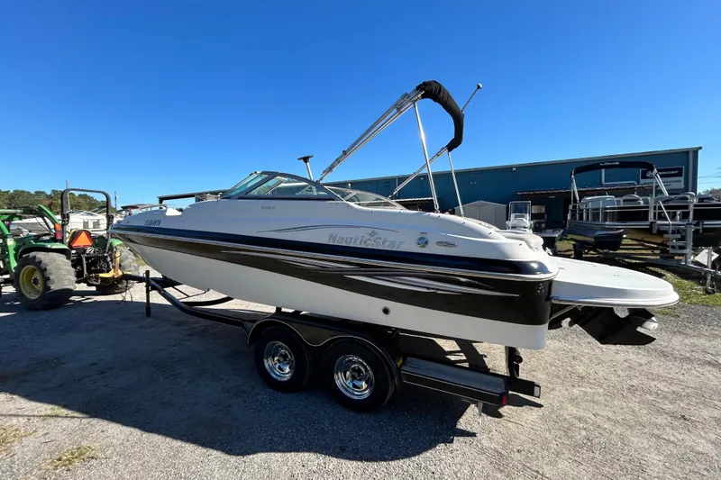 Slide: The Image of 2008 NauticStar 232DC Sport Deck boat on trailer under clear blue sky. - 15