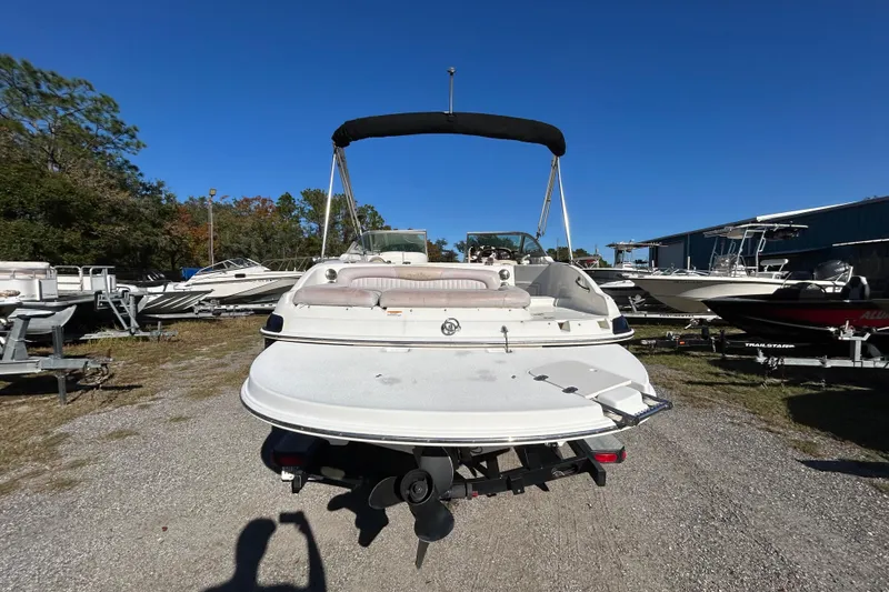 Slide: The Image of 2008 NauticStar 232DC Sport Deck boat on trailer, parked outdoors under clear blue sky. - 16