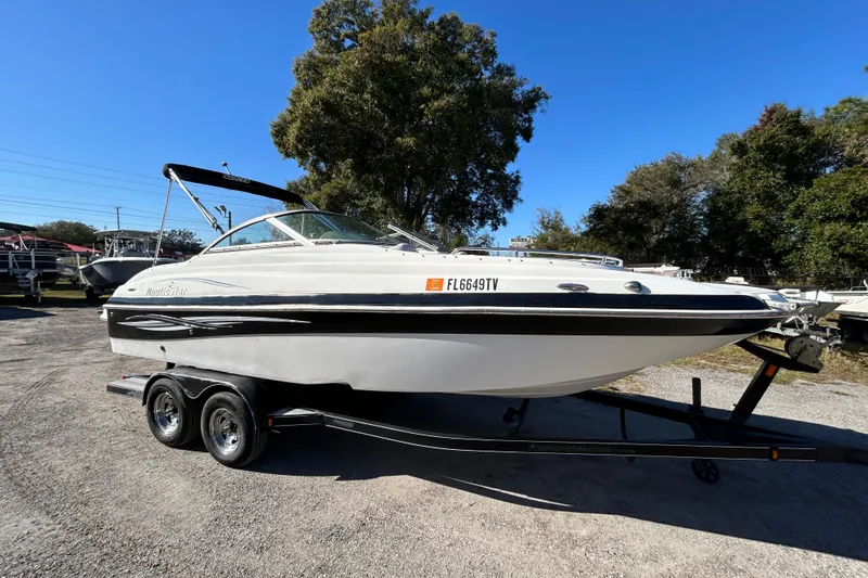 Slide: The Image of 2008 NauticStar 232DC Sport Deck boat on trailer, parked outdoors under clear blue sky. - 19