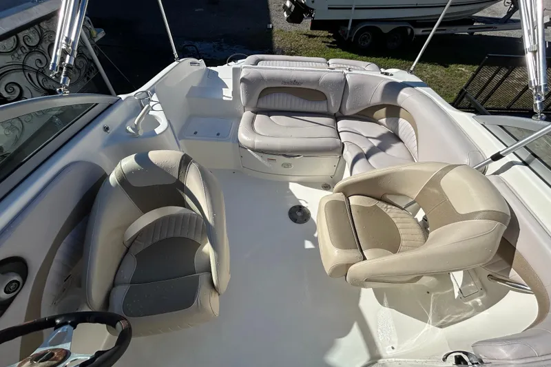 Slide: The Image of 2008 NauticStar 232DC Sport Deck boat interior with beige seating and steering wheel. - 4