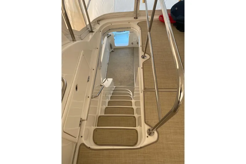 Slide: The Image of Staircase on 2008 Silverton 45 Convertible yacht with sleek metal railings. - 12