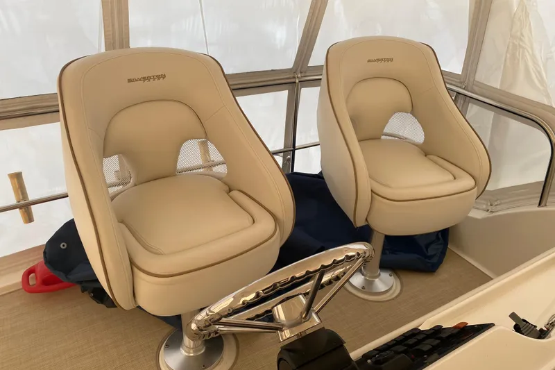Slide: The Image of Luxury helm seats on a 2008 Silverton 45 Convertible yacht, featuring beige upholstery. - 17