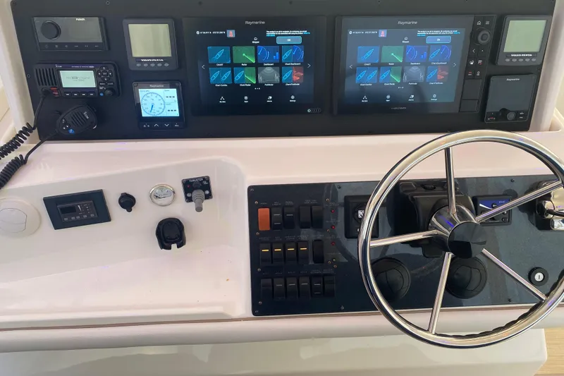 Slide: The Image of 2008 Silverton 45 Convertible yacht helm with advanced navigation controls and dual displays. - 18