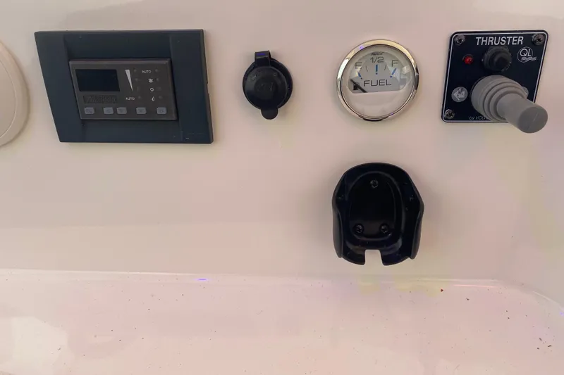 Slide: The Image of Control panel of a 2008 Silverton 45 Convertible boat with fuel gauge and thruster controls. - 21