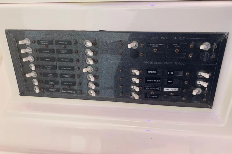 Slide: The Image of Control panel of a 2008 Silverton 45 Convertible boat with labeled switches and electronics. - 24