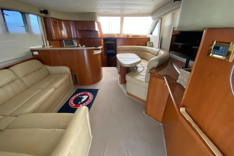 Slide: The Image of Luxurious interior of a 2008 Silverton 45 Convertible yacht with plush seating and modern amenities. - 25