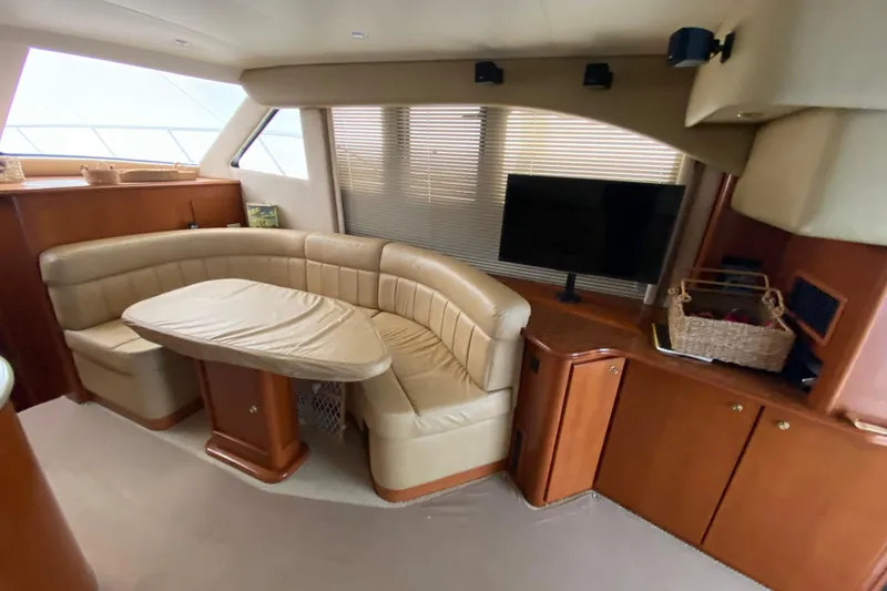 Slide: The Image of Luxurious interior of a 2008 Silverton 45 Convertible yacht with leather seating and TV. - 28