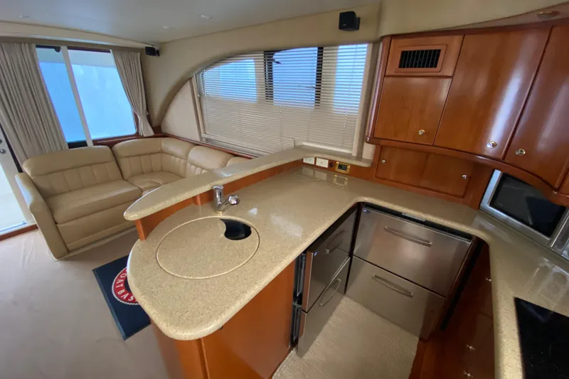 Slide: The Image of Luxurious interior of 2008 Silverton 45 Convertible yacht with modern kitchen and seating area. - 29