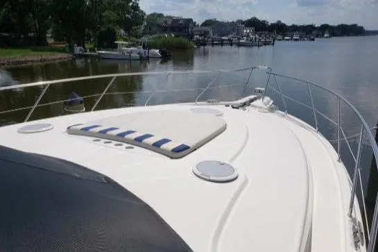 Slide: The Image of 2008 Silverton 45 Convertible yacht on calm waters, showcasing spacious deck and sleek design. - 3