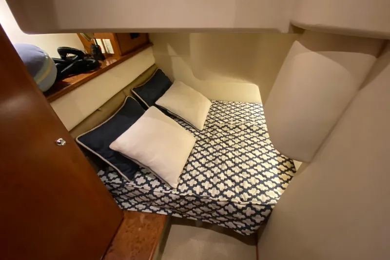 Slide: The Image of Cozy cabin interior of 2008 Silverton 45 Convertible yacht with patterned bedding. - 34