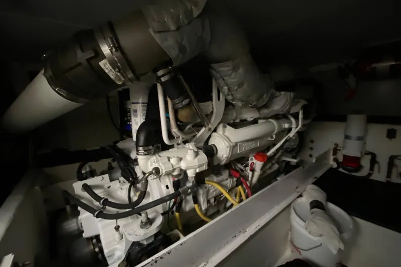 Slide: The Image of Engine room of 2008 Silverton 45 Convertible yacht, showcasing complex machinery and components. - 43