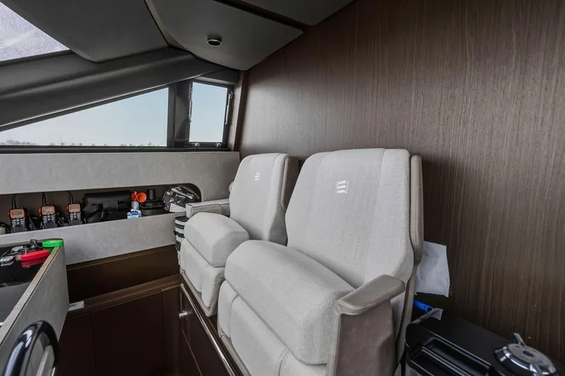 Slide: The Image of Luxurious interior of 2023 Ferretti Yachts 860 with plush seating and modern controls. - 21