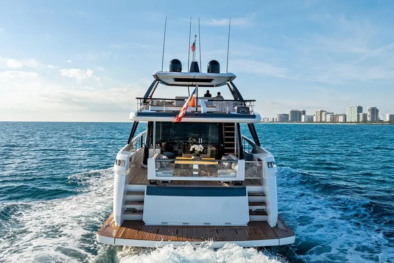 Slide: The Image of 2023 Ferretti Yachts 860 cruising on open sea with city skyline backdrop. - 4
