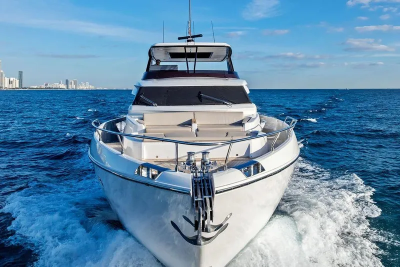 Slide: The Image of 2023 Ferretti Yachts 860 cruising on open sea with city skyline in background. - 6