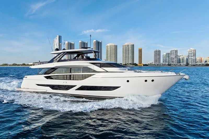 Slide: The Image of 2023 Ferretti Yachts 860 cruising near city skyline on a sunny day. - 1