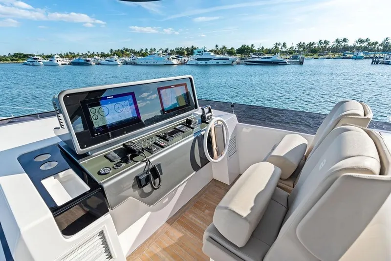 Slide: The Image of Helm of 2023 Ferretti Yachts 860 with modern navigation systems, overlooking marina. - 23