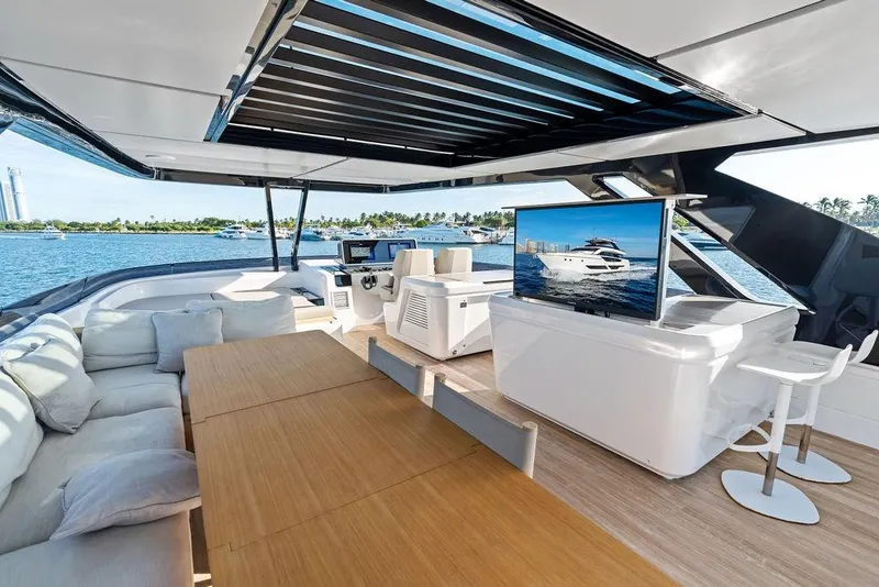Slide: The Image of Luxurious 2023 Ferretti Yachts 860 interior with modern seating, TV, and ocean view. - 28