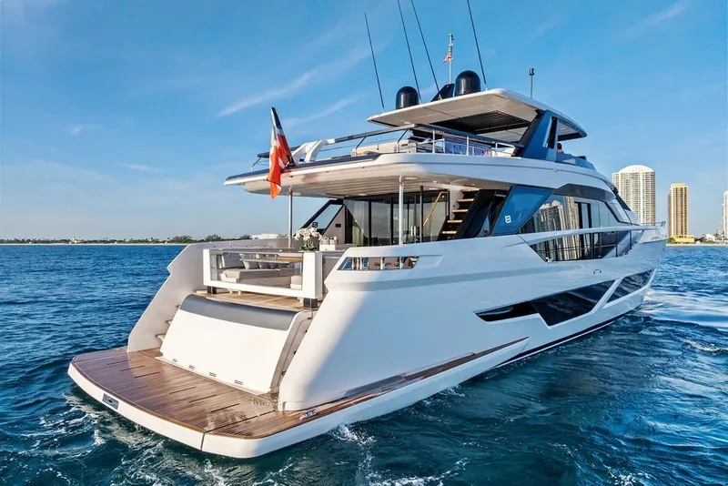 Slide: The Image of 2023 Ferretti Yachts 860 cruising on blue ocean with city skyline backdrop. - 3