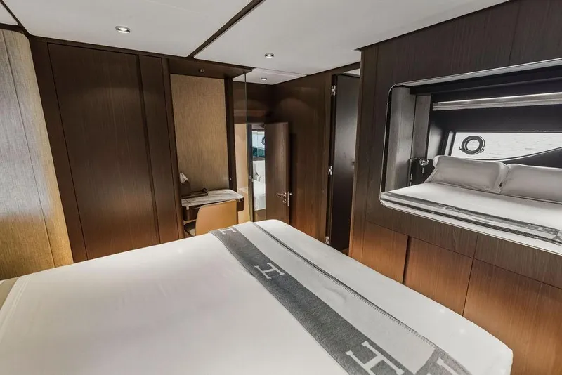 Slide: The Image of Luxurious bedroom interior of 2023 Ferretti Yachts 860 with elegant wood paneling. - 46