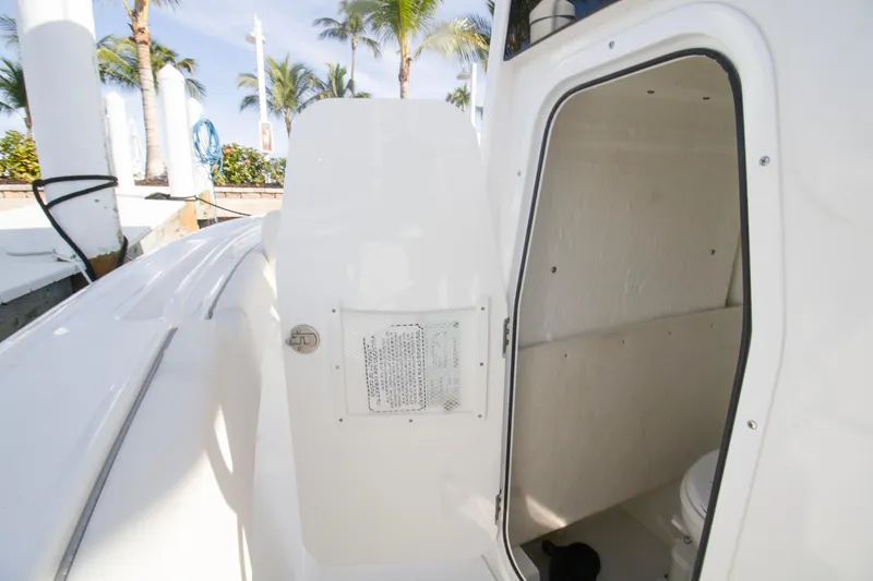 Slide: The Image of 2026 Sea Hunt Ultra 245 SE boat interior with open cabin door. - 10