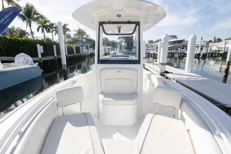 Slide: The Image of 2026 Sea Hunt Ultra 245 SE boat interior at marina, featuring sleek seating and modern design. - 12