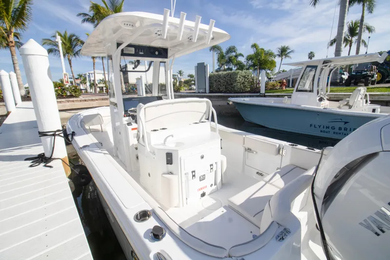 Slide: The Image of 2026 Sea Hunt Ultra 245 SE boat docked, featuring spacious seating and modern design. - 3