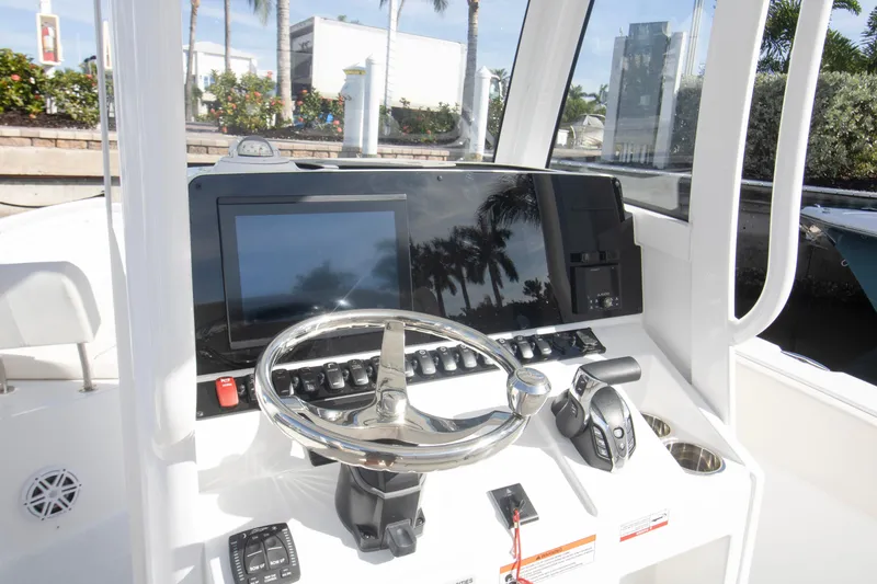 Slide: The Image of 2026 Sea Hunt Ultra 245 SE boat dashboard with steering wheel and control panel. - 9