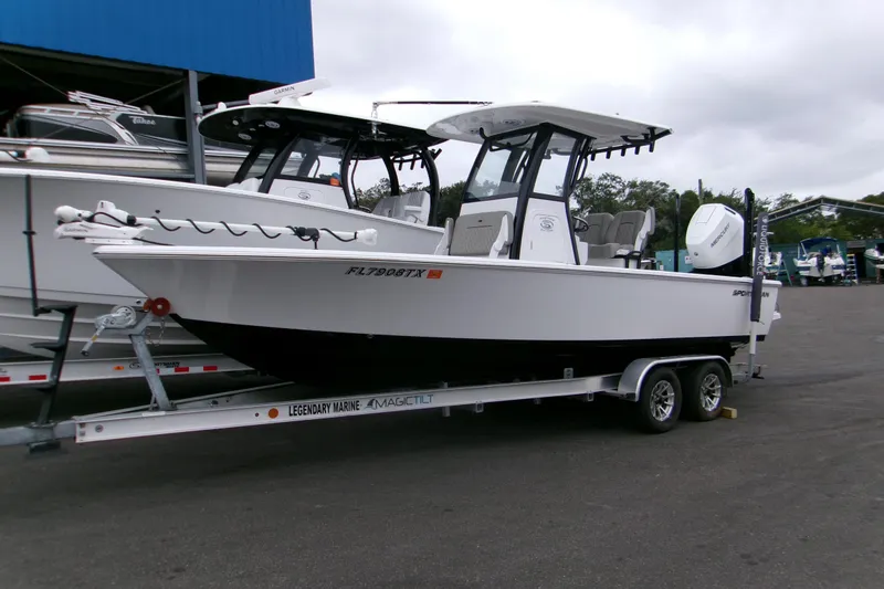 The Image of 2024 Sportsman Masters 267OE Bay Boat on trailer at marina. - 0