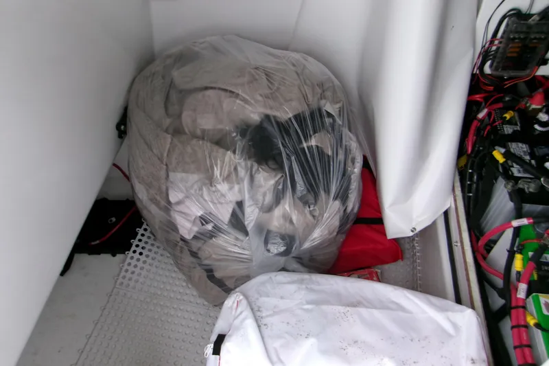 Slide: The Image of Storage compartment of 2024 Sportsman Masters 267OE Bay Boat with equipment and wiring. - 12