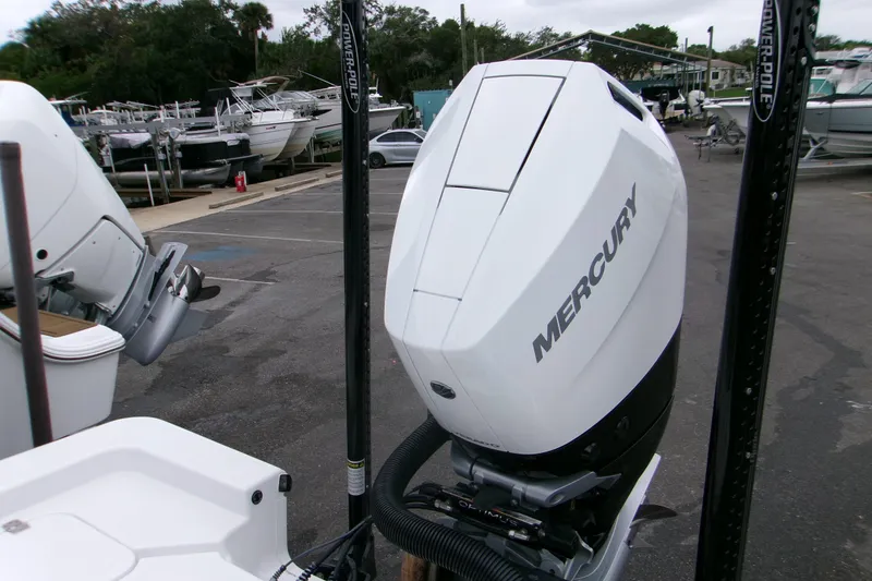 Slide: The Image of 2024 Sportsman Masters 267OE Bay Boat with Mercury outboard engine in a marina setting. - 14