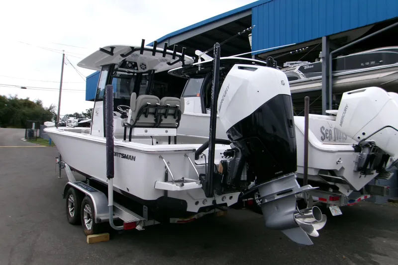 Slide: The Image of 2024 Sportsman Masters 267OE Bay Boat with dual Mercury engines on a trailer. - 21