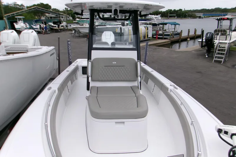 Slide: The Image of 2024 Sportsman Masters 267OE Bay Boat docked, showcasing spacious seating and modern design. - 4