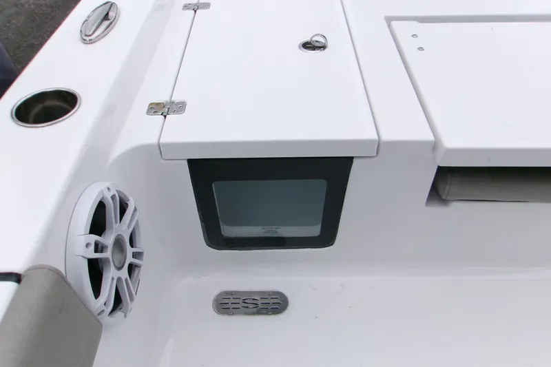Slide: The Image of 2024 Sportsman Masters 267OE Bay Boat interior with speaker and storage compartment. - 7