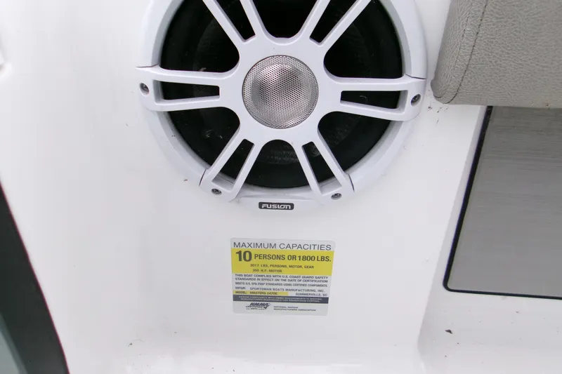 Slide: The Image of 2024 Sportsman Masters 267OE Bay Boat speaker and capacity label for 10 people or 1800 lbs. - 8